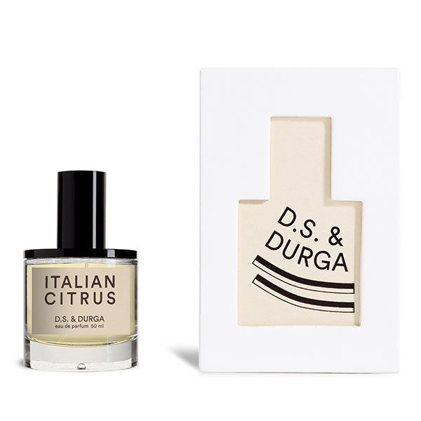 D.S. & Durga - Italian Citrus Parfümflakon mit schwarzem Verschluss neben weißer Verpackung mit minimalistischer Illustration