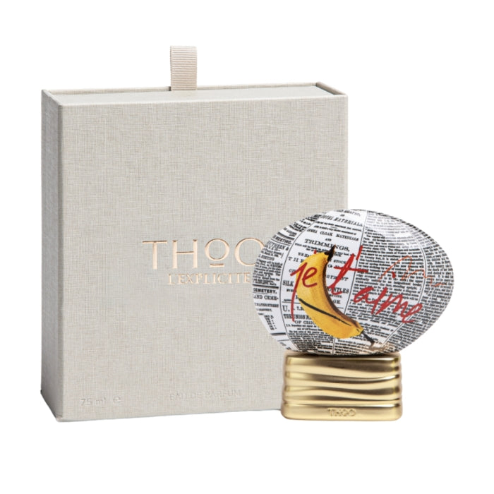 THoO - Crazy Collection - L'Explicite Flakon mit Bananenmotiv, Zeitungsdruck und goldenem Sockel vor beiger Verpackung