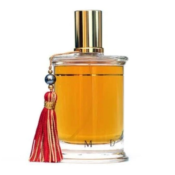 Parfums MDCI Paris - Péché Cardinal Flakon mit goldenem Verschluss und rotem Quastenanhänger vor weißem Hintergrund