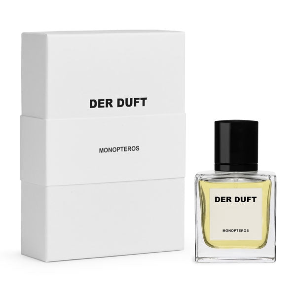 DER DUFT - Monopteros Parfumflakon mit klarem Glas, hellem Inhalt und schwarzem Verschluss neben weißer Verpackung