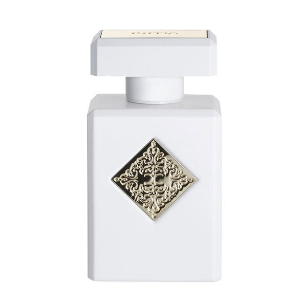 Initio - Hedonist Collection - Musk Therapy eleganter weißer Flakon mit verziertem silberfarbenem Emblem vor hellem Hintergrund