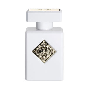 Initio - Hedonist Collection - Musk Therapy eleganter weißer Flakon mit verziertem silberfarbenem Emblem vor hellem Hintergrund