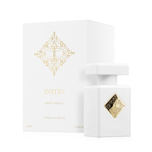 Initio - Hedonist Collection - Musk Therapy edler weißer Flakon mit goldenem Ornament und passender Verpackung vor weißem Hintergrund