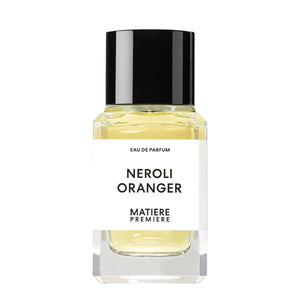 Matière Première - Neroli Oranger zeigt klaren Flakon mit hellem Parfum und schlichtem weißem Etikett mit schwarzer Kappe