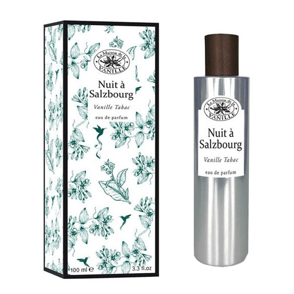 La Maison de la Vanille - Vanille Continental - Nuit à Salzbourg eleganter Flakon mit dunklem Holzverschluss neben floral bedruckter Verpackung