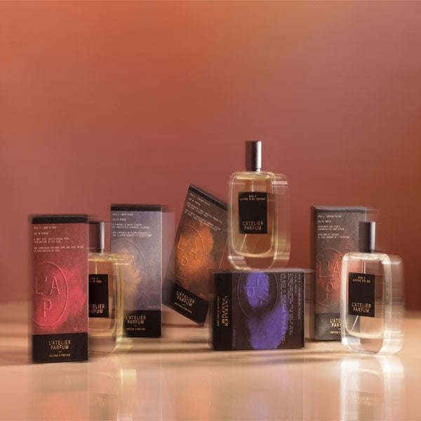 L'Atelier Parfum - Opus 2 - Leather Black (K)night Flakons und Verpackungen vor warmem, weichem Braunton Hintergrund