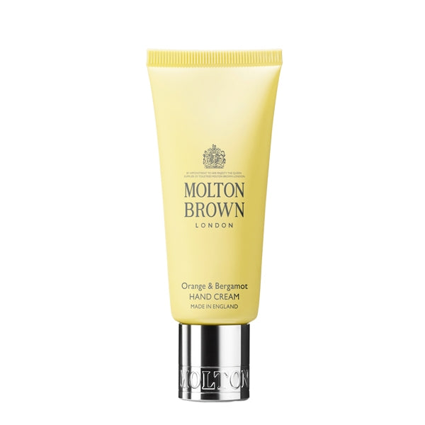 Molton Brown - Orange & Bergamot Hand Cream in gelber Tube mit silbernem Verschluss auf weißem Hintergrund