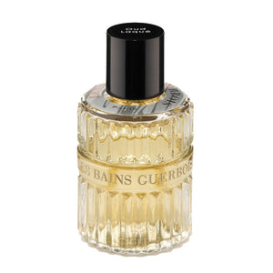 Les Bains Guerbois 1885 - Oud Laqué Parfumflakon mit goldgelbem Duft und geriffeltem Glas vor weißem Hintergrund