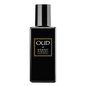 Piguet - Oud zeigt schwarzen, rechteckigen Parfumflakon mit goldumrahmtem Etikett und glänzendem Verschluss elegant gestaltet