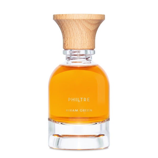 Hiram Green - Philtre Parfumflakon mit bernsteinfarbener Flüssigkeit und natürlichem Holzverschluss vor weißem Hintergrund