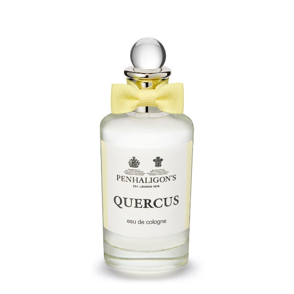Penhaligon's Quercus eau de cologne in clear glass bottle with silver stopper and pale yellow bow on white background
