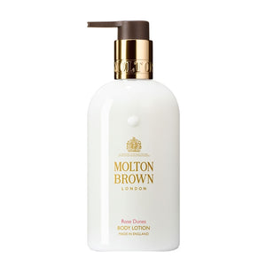 Molton Brown - Rose Dunes - Body Lotion mit goldfarbenem Spender auf weißem Hintergrund, edles Design