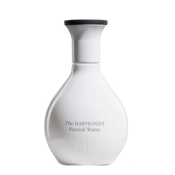 The Harmonist - Sacred Water Parfumflakon in elegantem weißem Design mit schwarzem Deckel vor weißem Hintergrund