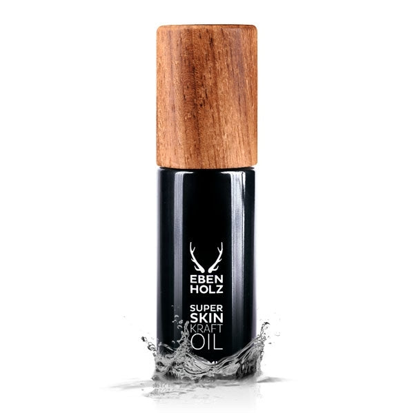 EBENHOLZ - Super Skin Kraft Oil schwarzer Flakon mit Holzdeckel und Wasserfontäne vor weißem Hintergrund