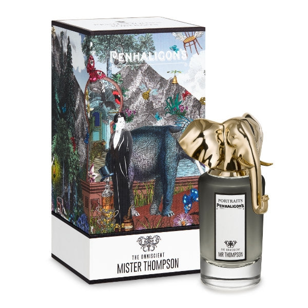 Penhaligon's - Portraits - The Omniscient Mr. Thompson zeigt Flakon mit goldenem Elefantenkopf vor fantasievoller Geschenkbox