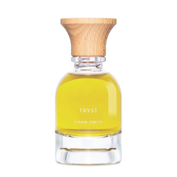 Hiram Green - Tryst Parfumflakon mit klarem Glas und Holzdeckel, gefüllt mit goldenem Öl vor weißem Hintergrund
