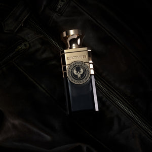 Electimuss - Vici Leather Flakon mit goldfarbenem Verschluss und dunklem Glas auf schwarzem Lederhintergrund