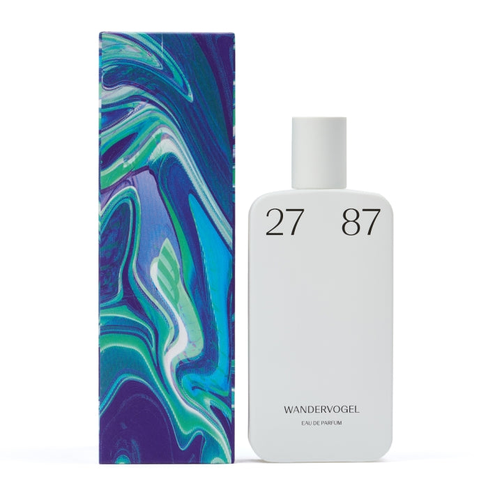 27 87 - wandervogel Parfumflakon in schlichtem Weiß mit minimalistischer Typografie neben farbenfroher, abstrakter Verpackung