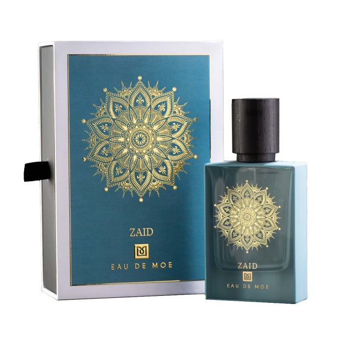 Eau De Moe - Zaid Parfumflakon in blaugrünem Glas mit schwarzem Holzdeckel und goldfarbenem Mandalamotiv neben eleganter Verpackung